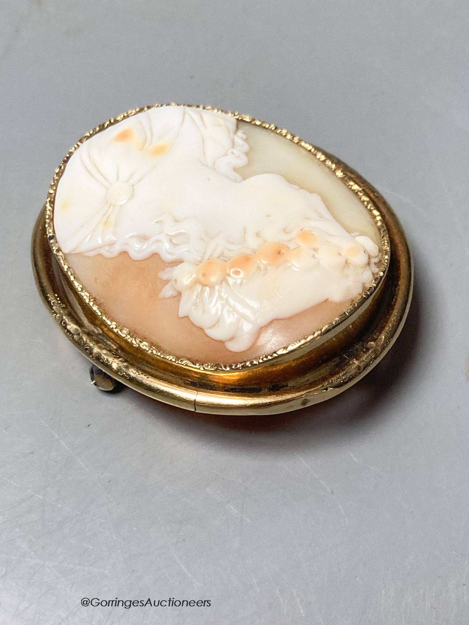 An early 20th century yellow metal mounted oval cameo shell brooch, carved with the bust of a lady to dexter, 47mm, gross 14.2 grams.